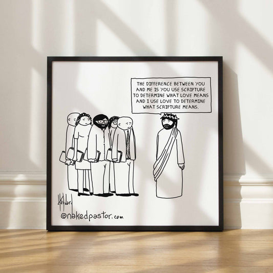 Framed cartoon print with religious theme on a white wall.